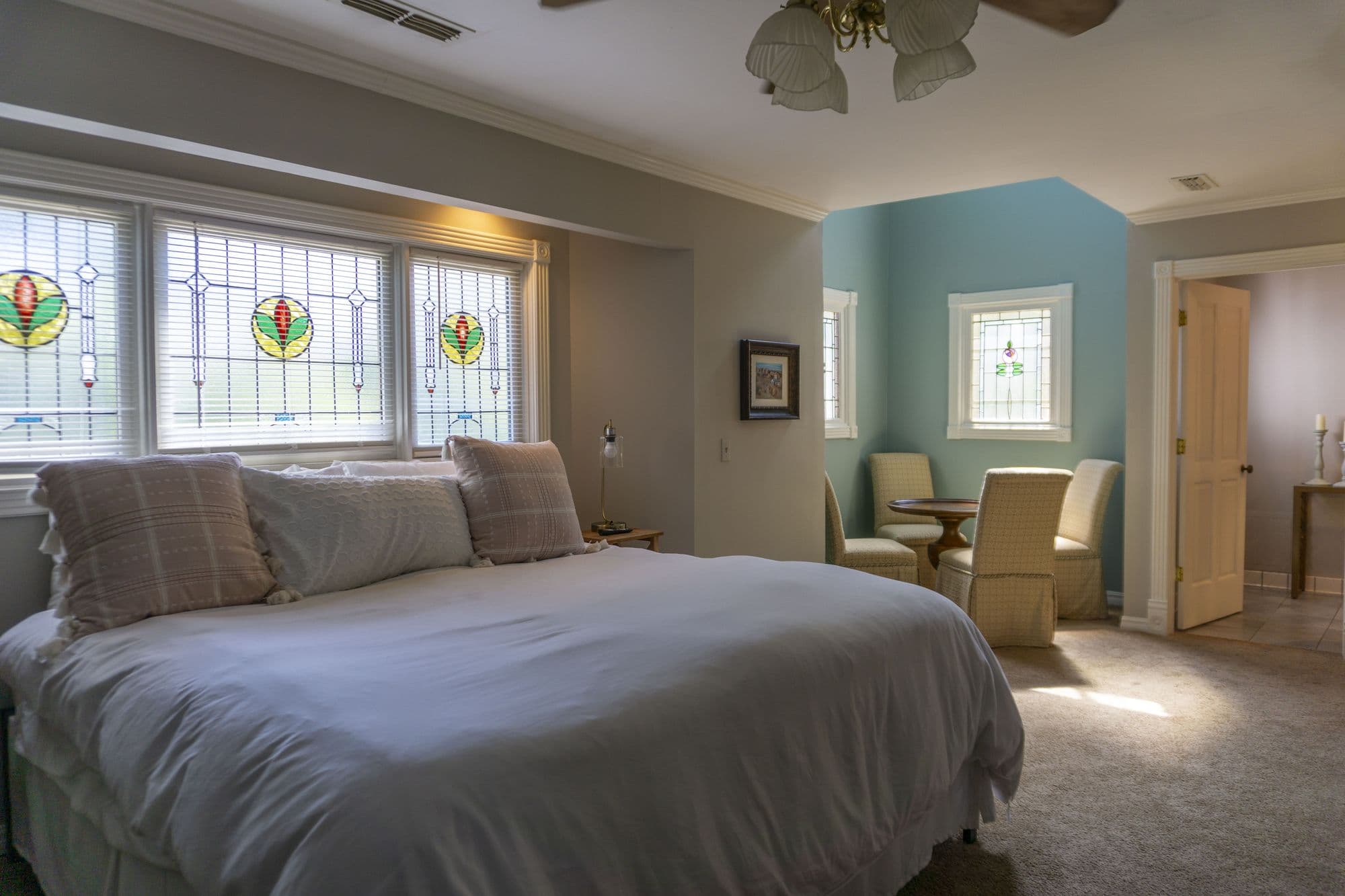 Fitzgerald Suite with a king bed and a sitting nook with a round table