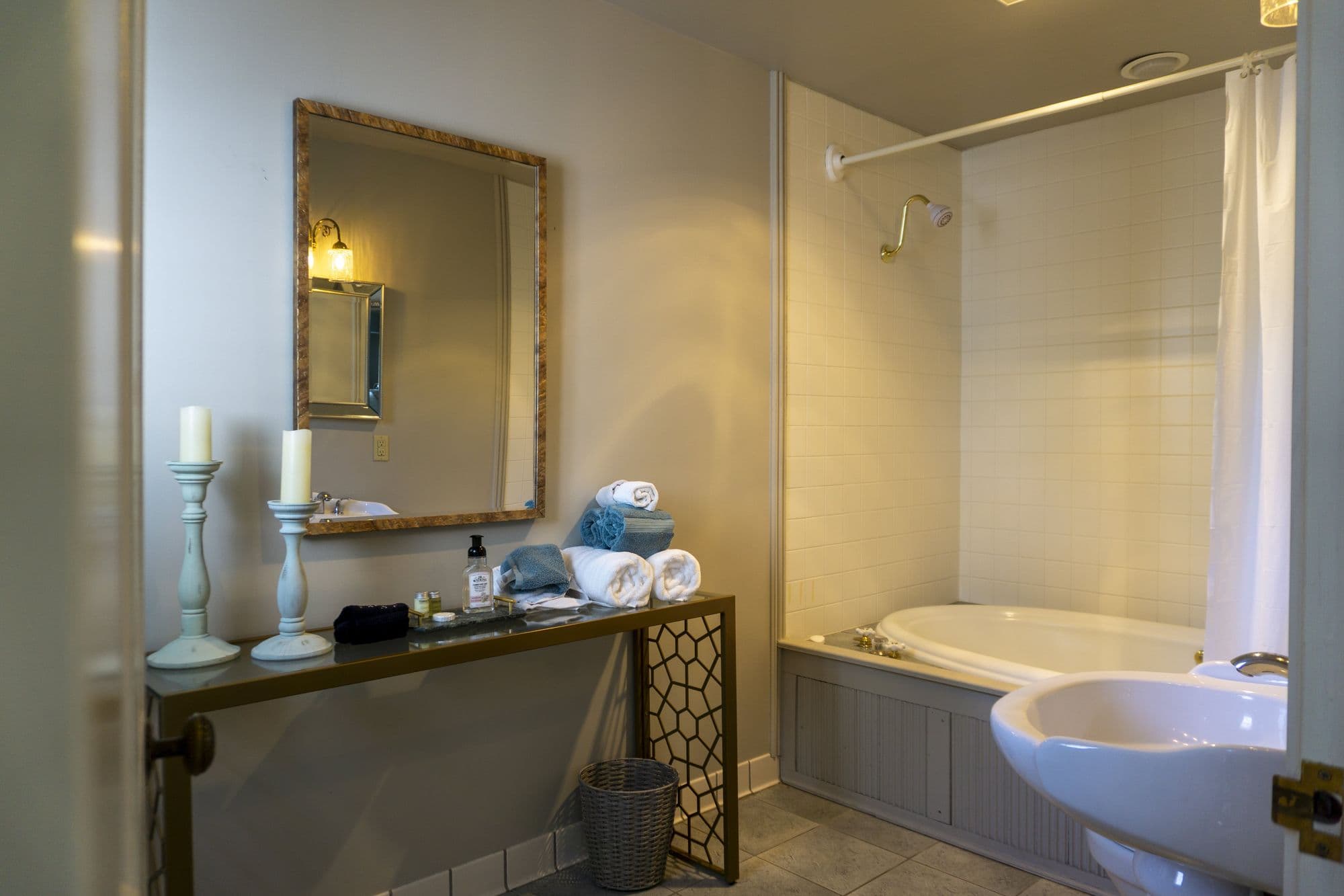 Candles, rolled towels and a framed mirror in the Fitzgerald Suite bathroom